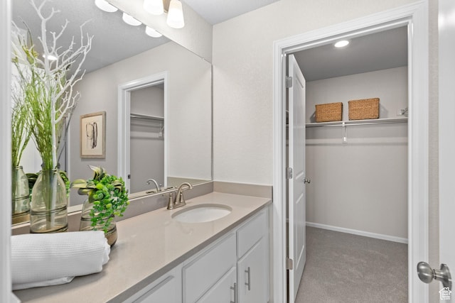 213 E 400 N Unit 980, Saratoga Springs, UT 84045 - bathroom featuring vanity, a walk in closet, and baseboards
