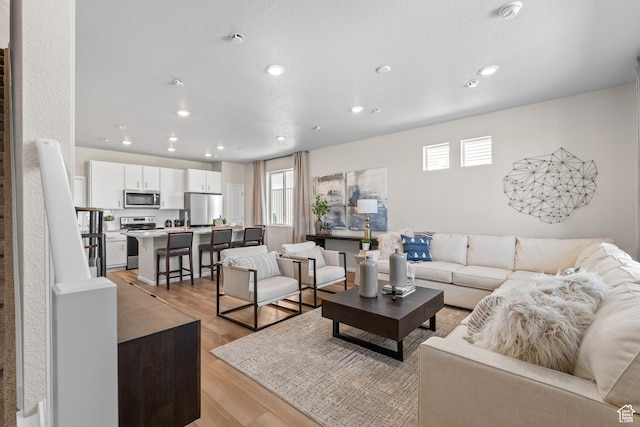 213 E 400 N Unit 980, Saratoga Springs, UT 84045 - living room featuring healthy amount of natural light, recessed lighting, and light wood-style floors