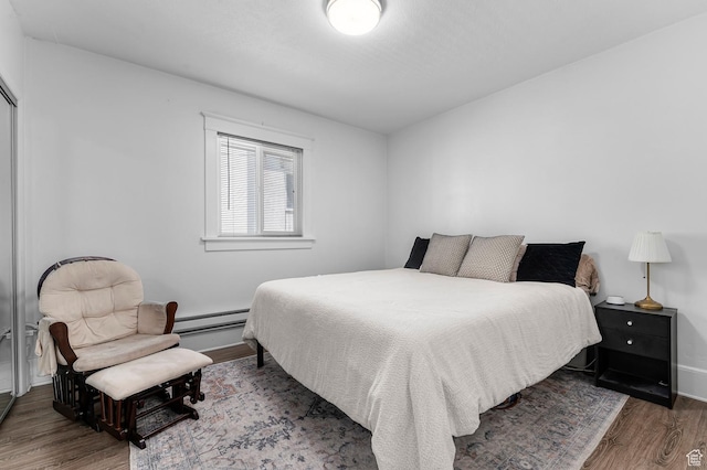 341 N 300 W, Provo, UT 84601 - bedroom featuring wood finished floors, a baseboard radiator, and baseboards