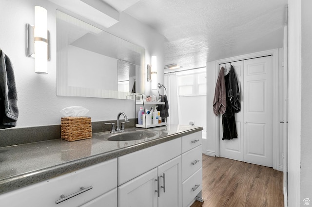 341 N 300 W, Provo, UT 84601 - bathroom with vanity, wood finished floors, and a textured ceiling