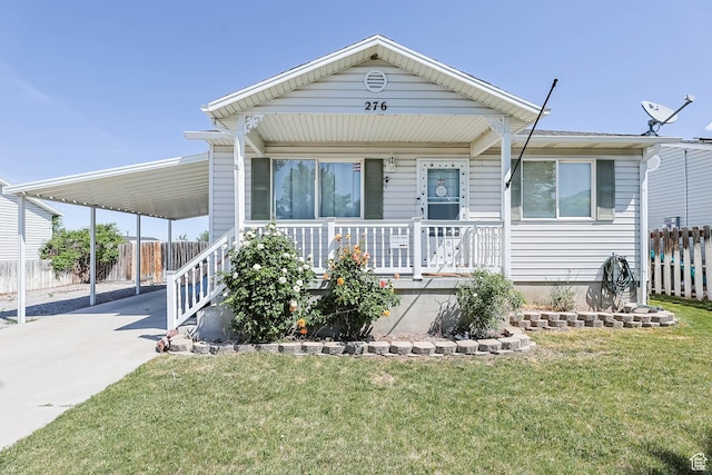 276 W 700 N, Tooele, UT 84074 - manufactured / mobile home with covered porch, driveway, and a carport