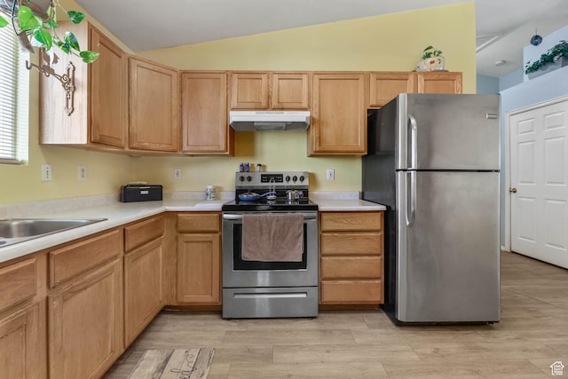 276 W 700 N, Tooele, UT 84074 - kitchen featuring appliances with stainless steel finishes, under cabinet range hood, light countertops, lofted ceiling, and light wood-style floors