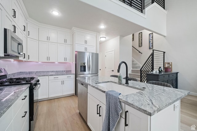 15002 S Wild Horse Way, Bluffdale, UT 84065 - kitchen featuring stainless steel appliances, a sink, light wood-type flooring, white cabinetry, and recessed lighting