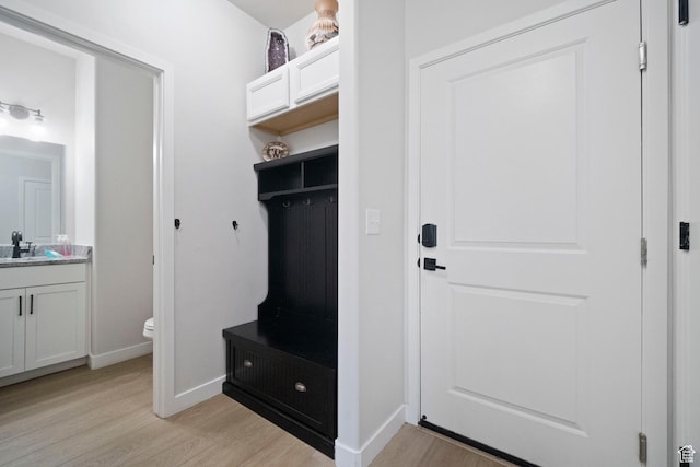 15002 S Wild Horse Way, Bluffdale, UT 84065 - mudroom featuring light wood-type flooring, baseboards, and a sink
