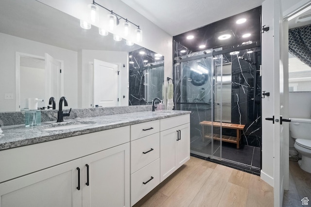 15002 S Wild Horse Way, Bluffdale, UT 84065 - bathroom featuring double vanity, wood finished floors, toilet, and a marble finish shower