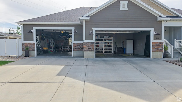 918 S River Ridge Lane, Spanish Fork, UT 84660 - view of front facade with stone siding, driveway, and an attached garage