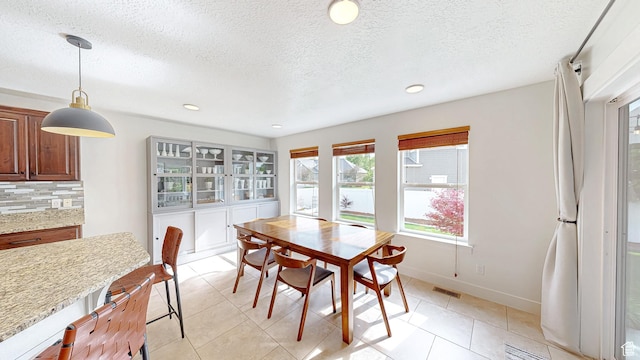 918 S River Ridge Lane, Spanish Fork, UT 84660 - dining space featuring plenty of natural light, a textured ceiling, light tile patterned floors, baseboards, and recessed lighting
