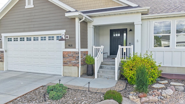 918 S River Ridge Lane, Spanish Fork, UT 84660 - doorway to property featuring stone siding, concrete driveway, a garage, board and batten siding, and roof with shingles
