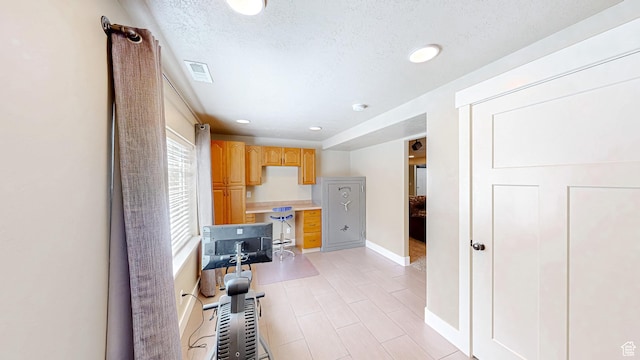 918 S River Ridge Lane, Spanish Fork, UT 84660 - kitchen featuring light brown cabinets, light countertops, baseboards, a textured ceiling, and an office area