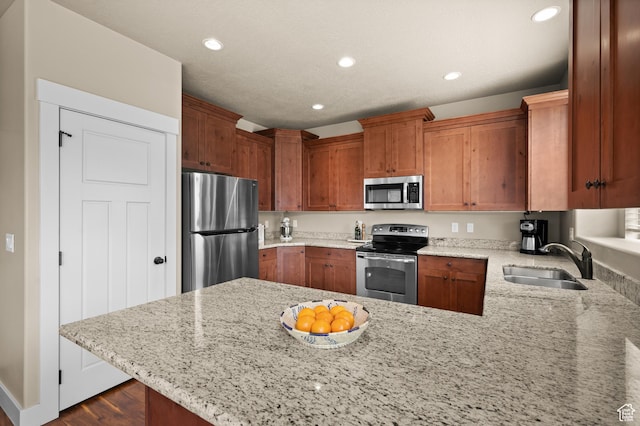 4117 W Shady Plum Way S, Jordan, UT 84009 - kitchen featuring stainless steel appliances, a sink, a peninsula, recessed lighting, and light stone countertops