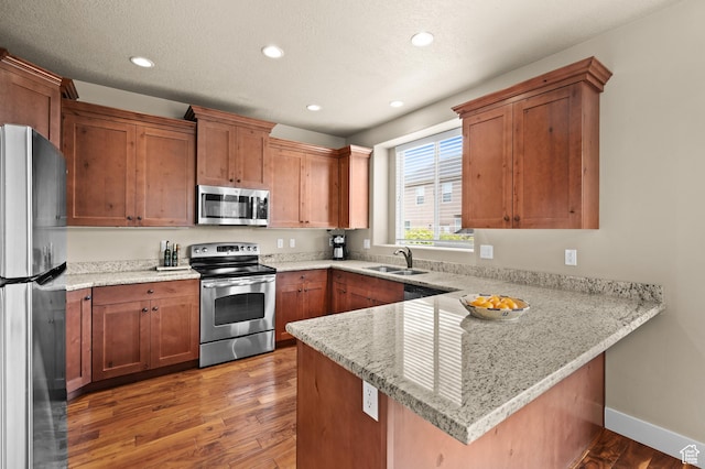 4117 W Shady Plum Way S, Jordan, UT 84009 - kitchen with stainless steel appliances, a peninsula, light wood finished floors, recessed lighting, and a sink