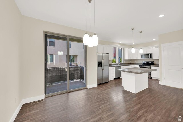 11379 S Oakmond Rd, South Jordan, UT 84009 - kitchen featuring stainless steel appliances, white cabinets, a kitchen island, dark wood-type flooring, and recessed lighting