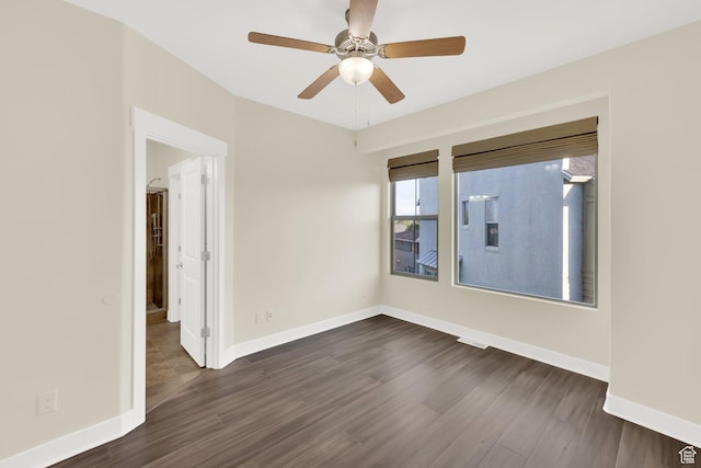 11379 S Oakmond Rd, South Jordan, UT 84009 - spare room featuring dark wood-type flooring, a ceiling fan, and baseboards