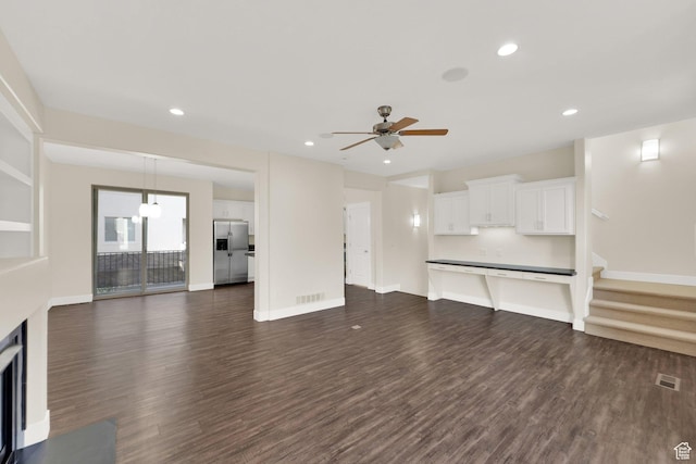11379 S Oakmond Rd, South Jordan, UT 84009 - unfurnished living room featuring dark wood-style flooring, ceiling fan, recessed lighting, baseboards, and a fireplace