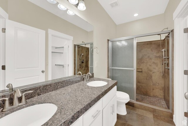 11379 S Oakmond Rd, South Jordan, UT 84009 - full bathroom with a shower stall, double vanity, toilet, tile patterned floors, and a spacious closet