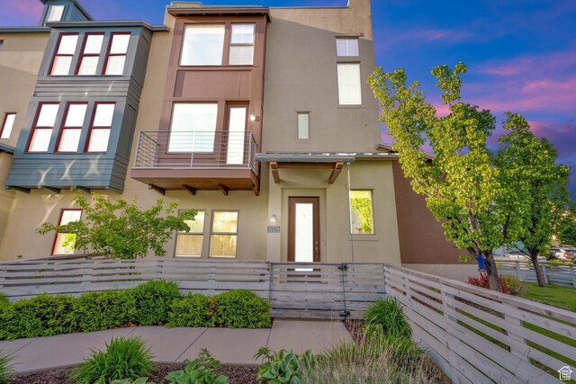11379 S Oakmond Rd, South Jordan, UT 84009 - view of front facade featuring stucco siding and a balcony