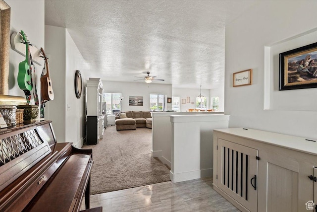 449 Travertine Way, Santaquin, UT 84655 - hallway featuring a textured ceiling and light colored carpet