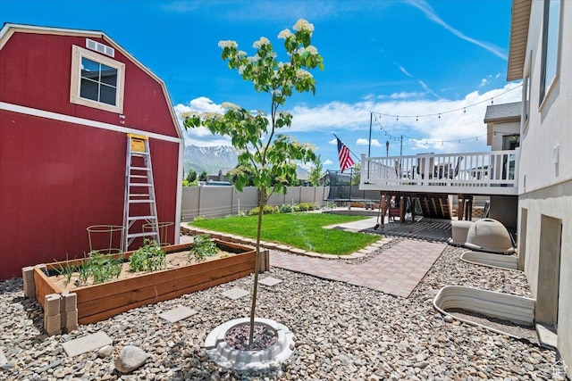 449 Travertine Way, Santaquin, UT 84655 - view of yard featuring a garden, a trampoline, a deck with mountain view, and a patio