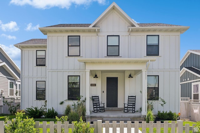 11051 S Mission Oaks Dr W, South Jordan, UT 84009 - modern inspired farmhouse featuring board and batten siding, covered porch, roof with shingles, and a fenced front yard