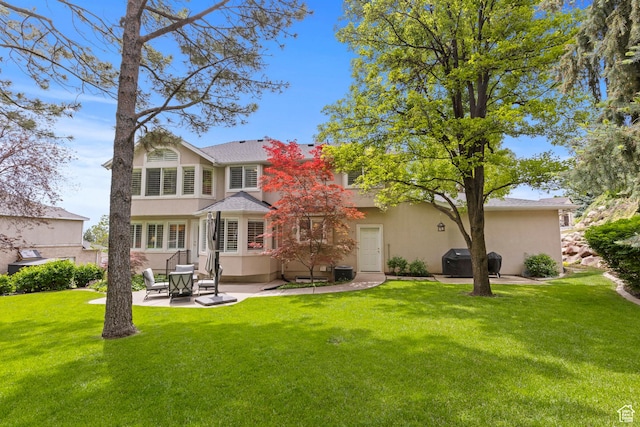 3330 N 175 W, North Ogden, UT 84414 - back of property with stucco siding, a patio, and a yard