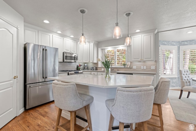 3330 N 175 W, North Ogden, UT 84414 - kitchen with appliances with stainless steel finishes, a kitchen breakfast bar, light countertops, recessed lighting, and white cabinetry