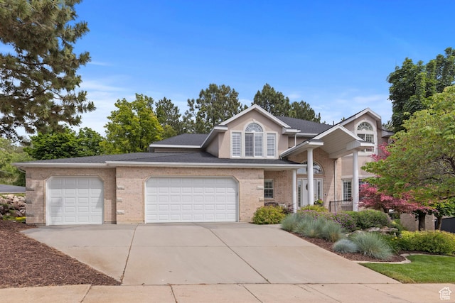3330 N 175 W, North Ogden, UT 84414 - view of front facade featuring concrete driveway, an attached garage, brick siding, and a shingled roof