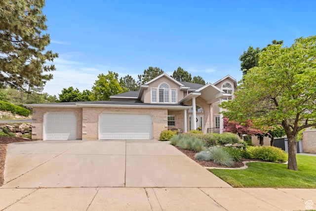 3330 N 175 W, North Ogden, UT 84414 - traditional-style house featuring a garage, driveway, a front yard, and brick siding