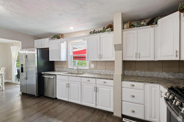 761 N Highland Blvd, Brigham City, UT 84302 - kitchen with appliances with stainless steel finishes, a sink, white cabinetry, backsplash, and recessed lighting