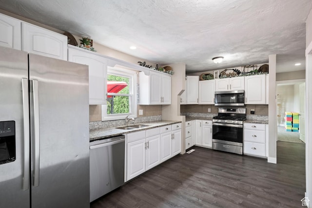 761 N Highland Blvd, Brigham City, UT 84302 - kitchen with stainless steel appliances, a sink, white cabinets, dark wood finished floors, and recessed lighting