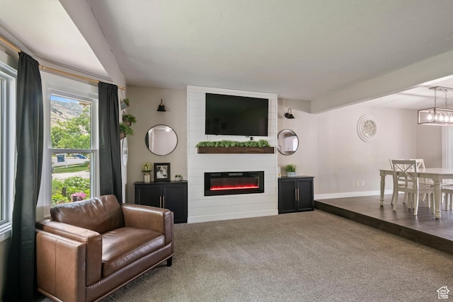 761 N Highland Blvd, Brigham City, UT 84302 - carpeted living room featuring a fireplace and baseboards