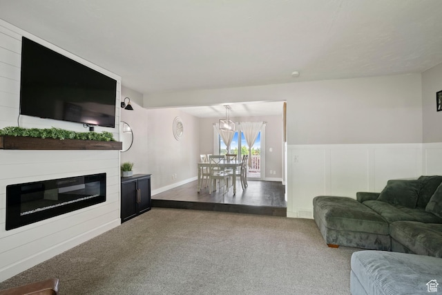 761 N Highland Blvd, Brigham City, UT 84302 - living area featuring carpet floors, a decorative wall, a glass covered fireplace, and a wainscoted wall