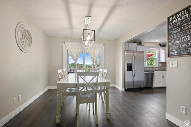 761 N Highland Blvd, Brigham City, UT 84302 - dining room with baseboards and dark wood-type flooring