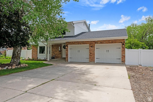 761 N Highland Blvd, Brigham City, UT 84302 - view of front of house with an attached garage, driveway, brick siding, and board and batten siding