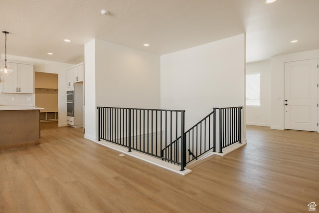 2597 E 360 S Unit 16, Spanish Fork, UT 84660 - corridor featuring an upstairs landing, light wood finished floors, recessed lighting, and baseboards
