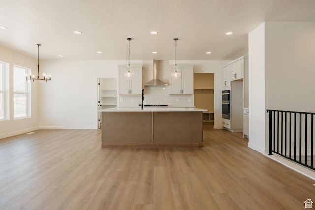 2597 E 360 S Unit 16, Spanish Fork, UT 84660 - kitchen with wall chimney range hood, tasteful backsplash, double oven, light wood-type flooring, and white cabinetry