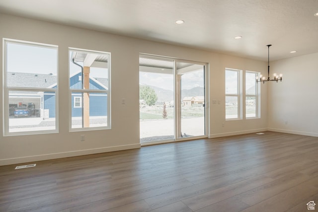 2597 E 360 S Unit 16, Spanish Fork, UT 84660 - spare room with a chandelier, wood finished floors, baseboards, recessed lighting, and a mountain view
