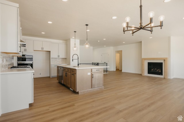 2597 E 360 S Unit 16, Spanish Fork, UT 84660 - kitchen with a sink, recessed lighting, stainless steel dishwasher, light wood finished floors, and decorative backsplash