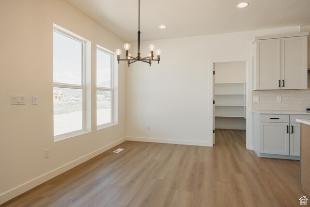 2597 E 360 S Unit 16, Spanish Fork, UT 84660 - unfurnished dining area featuring a chandelier, light wood finished floors, baseboards, and recessed lighting