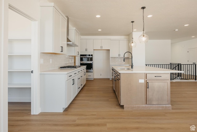 2597 E 360 S Unit 16, Spanish Fork, UT 84660 - kitchen with a sink, appliances with stainless steel finishes, light countertops, tasteful backsplash, and light wood-style floors