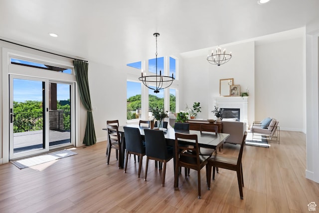 3812 S Mapleton Estates Dr, Mapleton, UT 84664 - dining room featuring a chandelier, light wood finished floors, recessed lighting, baseboards, and a glass covered fireplace