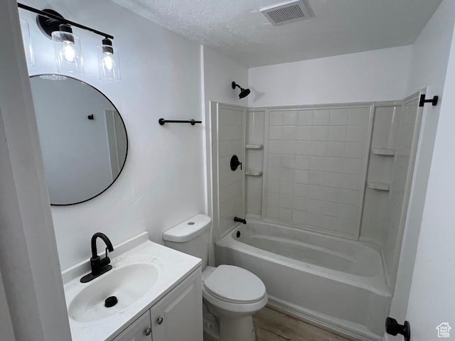 3222 W Tess Ave S, West Valley City, UT 84119 - bathroom with toilet, vanity, shower / bathtub combination, wood finished floors, and a textured ceiling