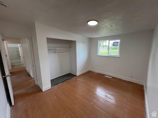 3222 W Tess Ave S, West Valley City, UT 84119 - unfurnished bedroom with wood finished floors, baseboards, and a closet