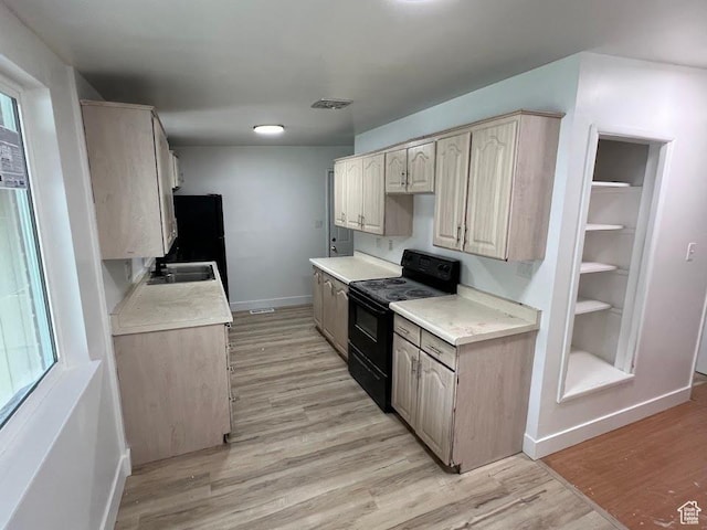 3222 W Tess Ave S, West Valley City, UT 84119 - kitchen with black appliances, baseboards, light countertops, and light wood-style floors
