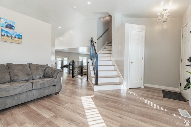 1428 N Reese Dr, Provo, UT 84601 - living room with stairway, baseboards, light wood-style flooring, a chandelier, and high vaulted ceiling