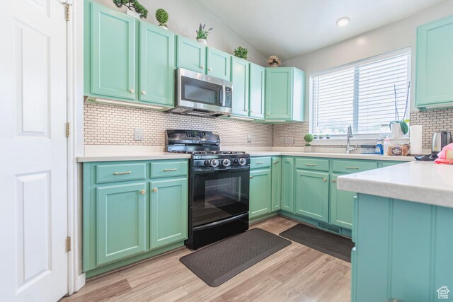 1428 N Reese Dr, Provo, UT 84601 - kitchen featuring stainless steel microwave, black range with gas cooktop, a sink, backsplash, and light countertops
