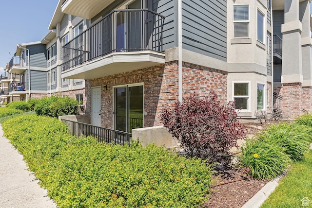116 E Resaca Unit F3, Midvale, UT 84070 - view of home's exterior featuring a balcony and brick siding