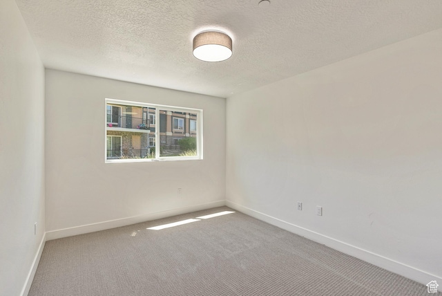 116 E Resaca Unit F3, Midvale, UT 84070 - empty room featuring carpet, baseboards, and a textured ceiling