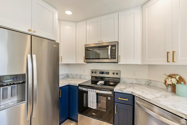 116 E Resaca Unit F3, Midvale, UT 84070 - kitchen with appliances with stainless steel finishes, white cabinets, blue cabinetry, and recessed lighting