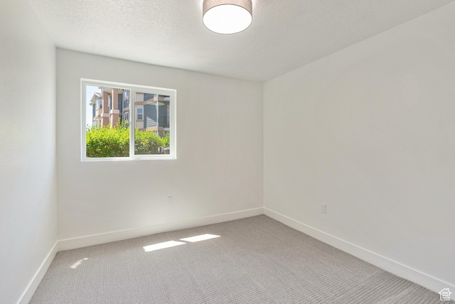 116 E Resaca Unit F3, Midvale, UT 84070 - carpeted spare room with baseboards and a textured ceiling