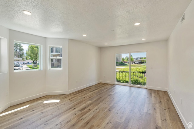 116 E Resaca Unit F3, Midvale, UT 84070 - empty room featuring healthy amount of natural light, a textured ceiling, baseboards, and recessed lighting